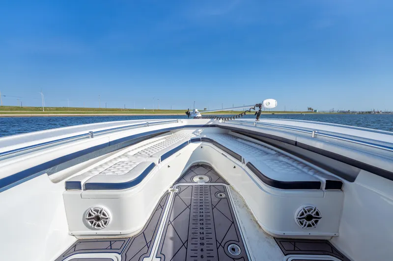 Slide: The Image of 2021 Yellowfin 32 Offshore boat interior with cushioned seating and sleek design on open water. - 6