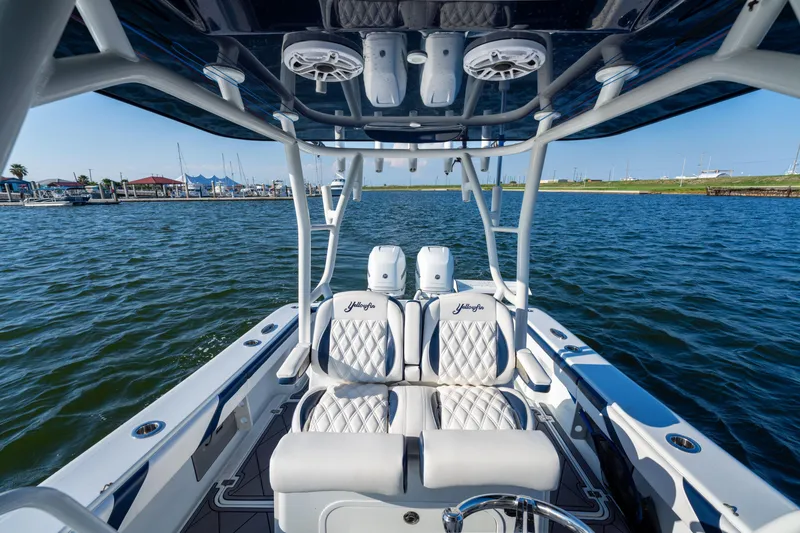 Slide: The Image of 2021 Yellowfin 32 Offshore boat interior with luxurious seating on open water. - 9