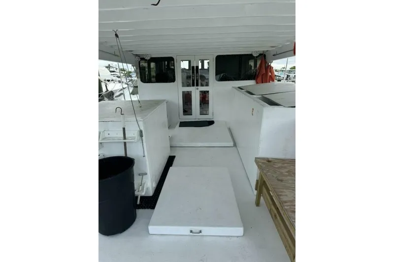 Slide: The Image of 1987 Monroe Custom 52 boat interior with white deck and fishing equipment. - 11