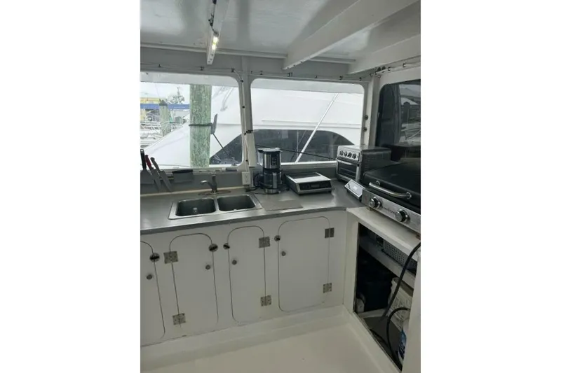 Slide: The Image of 1987 Monroe Custom 52 boat kitchen with sink, appliances, and storage cabinets. - 15