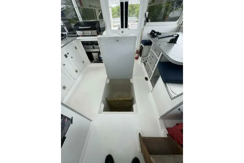 Slide: The Image of Interior of 1987 Monroe Custom 52 boat with open hatch and kitchen area. - 17