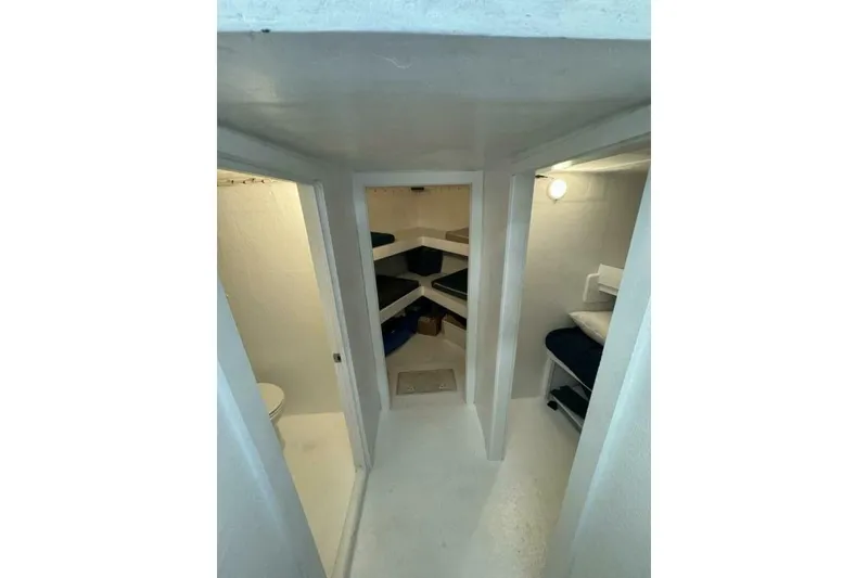 Slide: The Image of Interior of 1987 Monroe Custom 52 boat with compact sleeping quarters. - 18