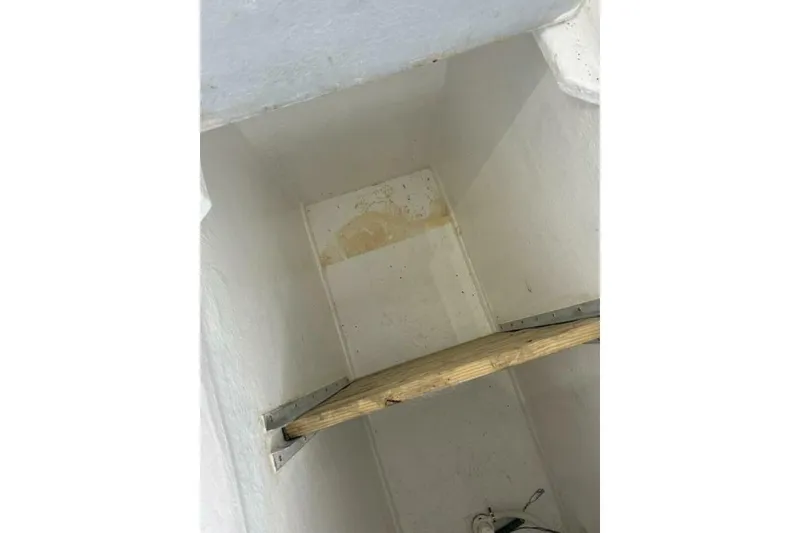 Slide: The Image of Interior view of a 1987 Monroe Custom 52 boat compartment with wooden support. - 19