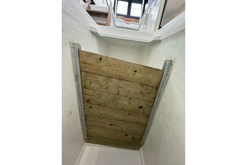 Slide: The Image of Wooden hatch inside 1987 Monroe Custom 52 boat, leading to upper deck. - 21