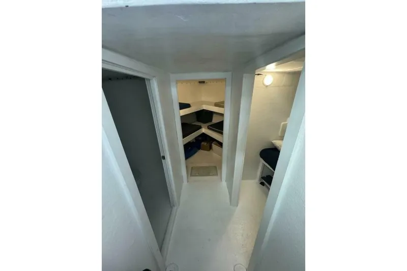 Slide: The Image of Interior of 1987 Monroe Custom 52 boat with bunk beds and compact design. - 22