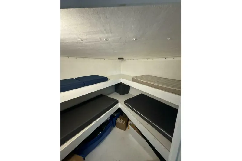 Slide: The Image of Interior cabin of 1987 Monroe Custom 52 with multiple cushioned bunks. - 27