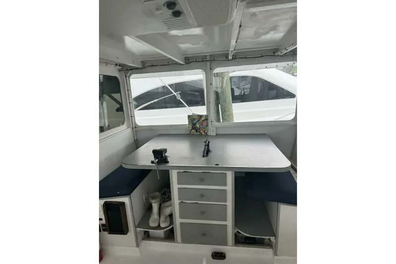 Slide: The Image of Interior of 1987 Monroe Custom 52 boat with table, seating, and storage. - 29