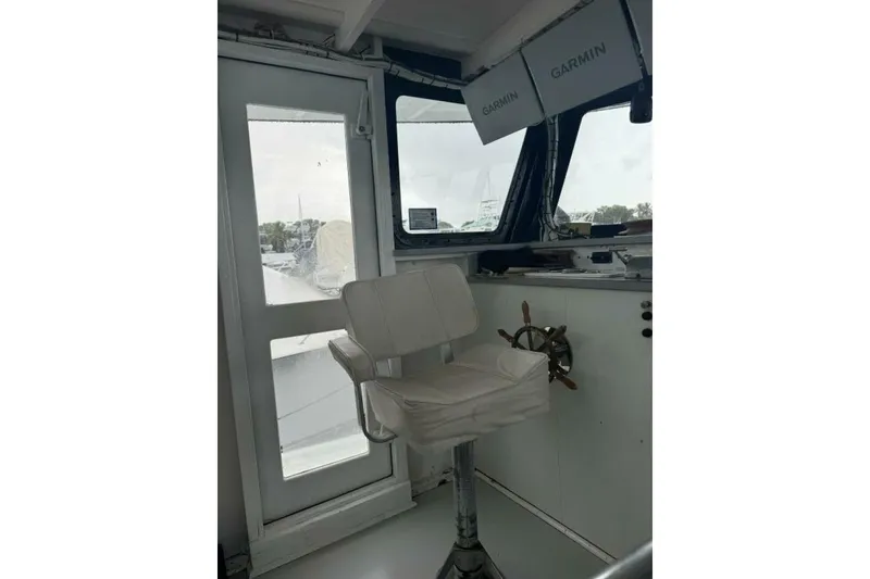 Slide: The Image of Interior of 1987 Monroe Custom 52 boat with captain's chair and navigation equipment. - 31