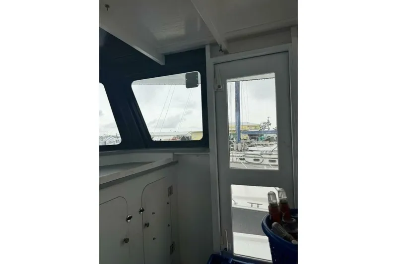 Slide: The Image of Interior view of 1987 Monroe Custom 52 boat with marina in background. - 34