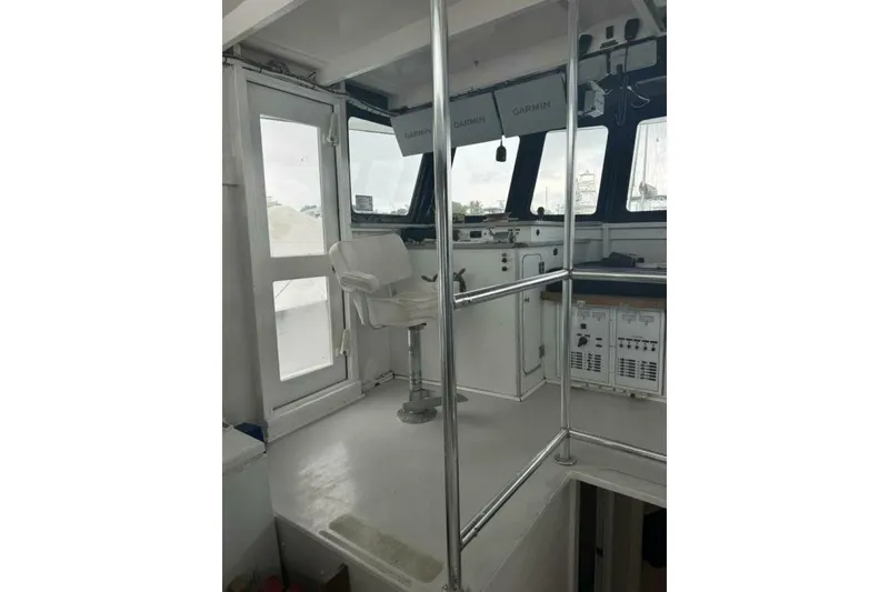 Slide: The Image of Interior of 1987 Monroe Custom 52 boat with navigation equipment and seating. - 9
