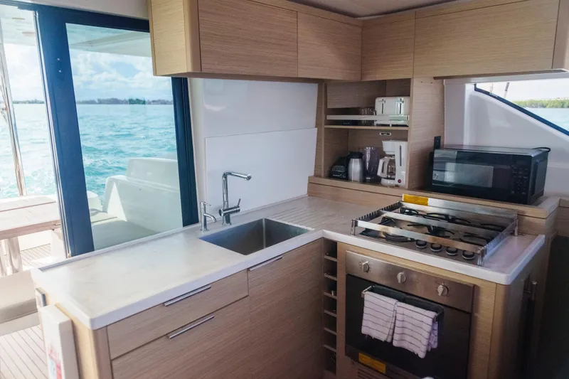 Slide: The Image of Modern kitchen interior of 2024 Lagoon 51 yacht with ocean view. - 28