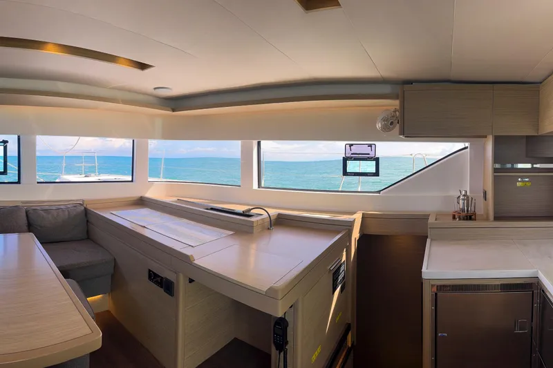 Slide: The Image of Luxurious interior of 2024 Lagoon 51 yacht with ocean view through large windows. - 31