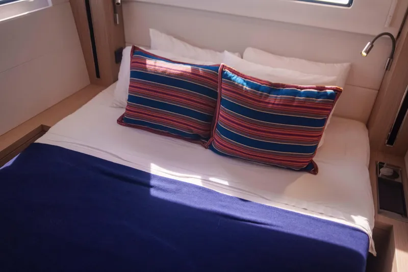 Slide: The Image of Cozy cabin bed with striped pillows in 2024 Lagoon 51 yacht. - 33
