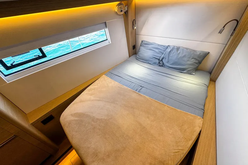 Slide: The Image of Luxurious cabin interior of 2024 Lagoon 51 yacht with cozy bed and ocean view. - 41