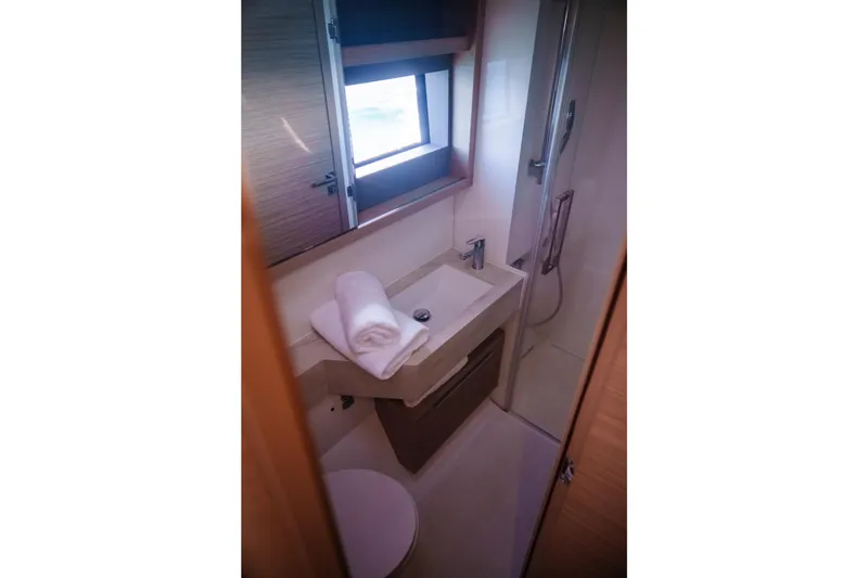 Slide: The Image of Modern bathroom interior of 2024 Lagoon 51 yacht with sink, shower, and window. - 42