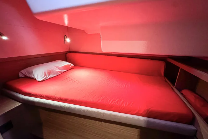 Slide: The Image of Cozy cabin interior with red bedding in 2024 Lagoon 51 yacht. - 46
