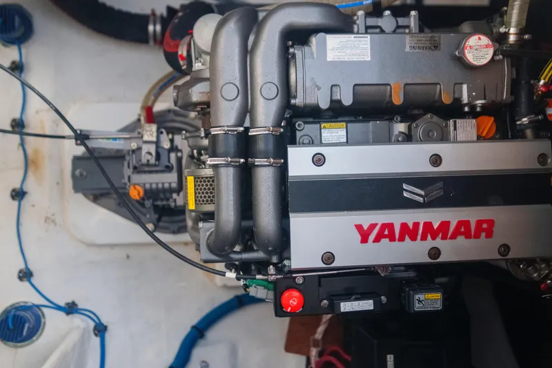 Slide: The Image of Engine compartment of a 2024 Lagoon 51 yacht featuring a Yanmar engine. - 49