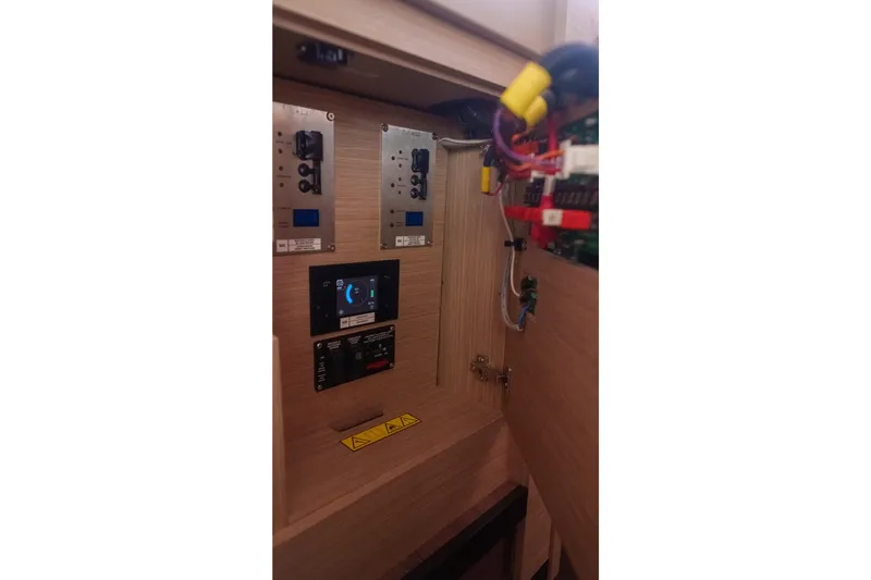 Slide: The Image of 2024 Lagoon 51 yacht electrical panel with wiring and control displays. - 51