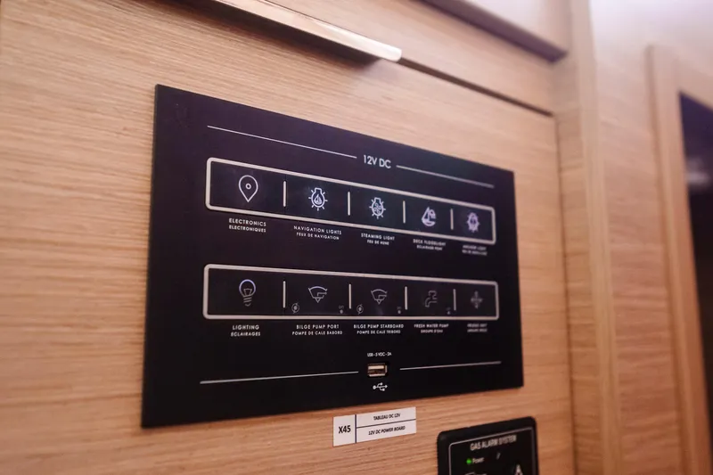 Slide: The Image of Control panel of 2024 Lagoon 51 yacht, featuring 12V DC electronic systems. - 52