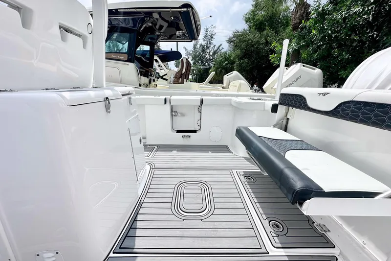 Slide: The Image of 2024 Tidewater 292 CC Adventure boat interior with seating and deck view. - 10
