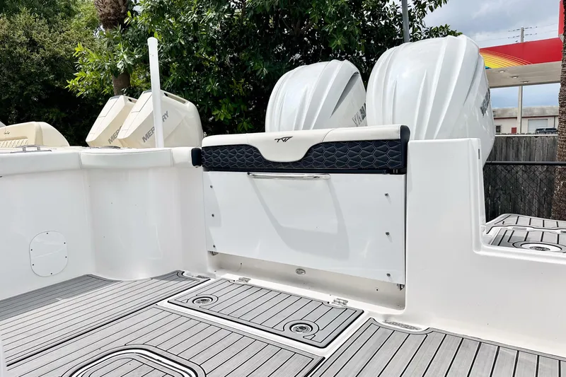 Slide: The Image of 2024 Tidewater 292 CC Adventure boat with dual outboard engines and spacious deck. - 11