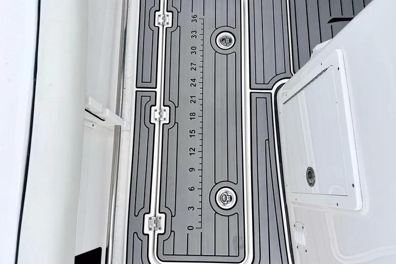 Slide: The Image of 2024 Tidewater 292 CC Adventure boat deck with measurement markings and storage hatch. - 13