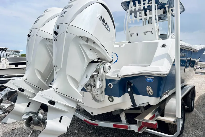 Slide: The Image of 2024 Tidewater 292 CC Adventure boat with dual Yamaha outboard engines on a trailer. - 3
