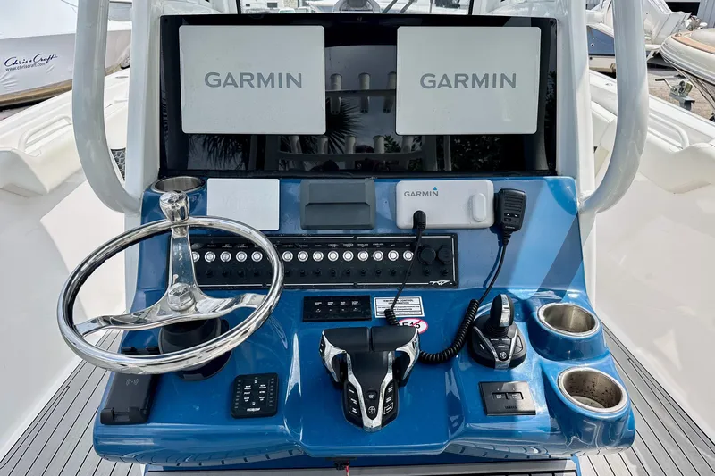 Slide: The Image of 2024 Tidewater 292 CC Adventure boat dashboard with Garmin navigation displays and controls. - 8