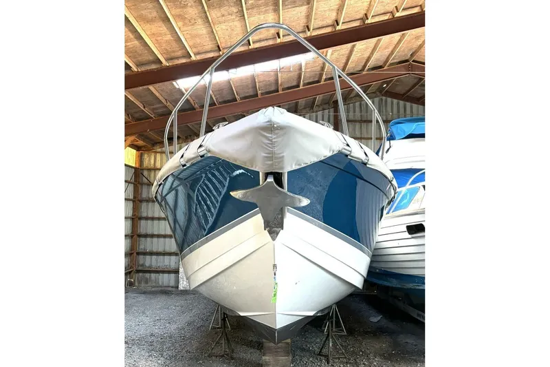 Slide: The Image of 2006 Formula 400 Super Sport Crossover boat stored in a wooden shed. - 10