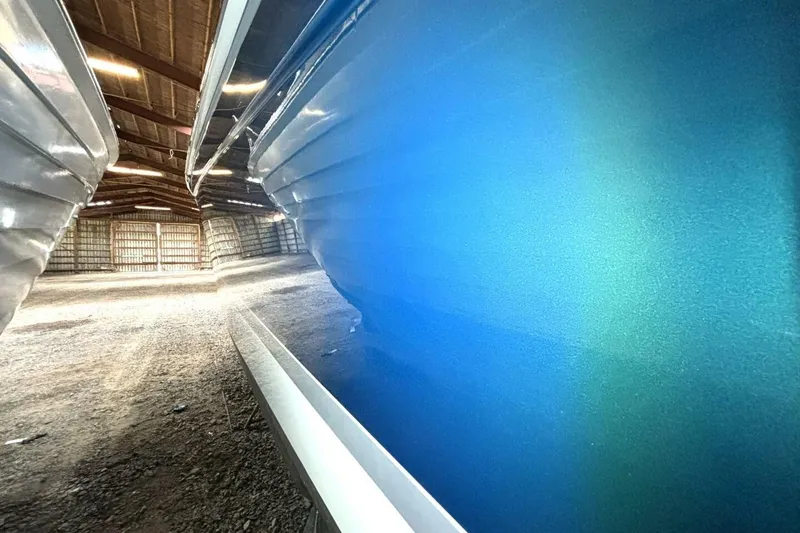 Slide: The Image of Blue hull of a 2006 Formula 400 Super Sport Crossover boat in storage. - 12