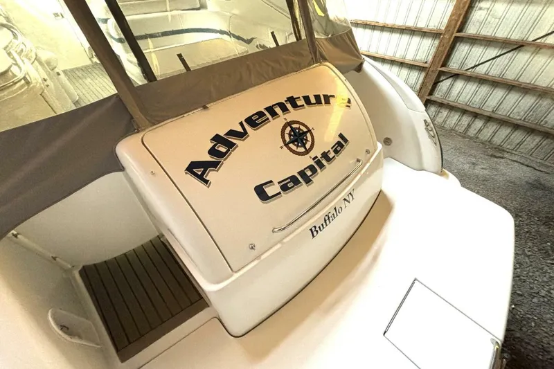 Slide: The Image of 2006 Formula 400 Super Sport Crossover boat with "Adventure Capital" name, docked indoors. - 14