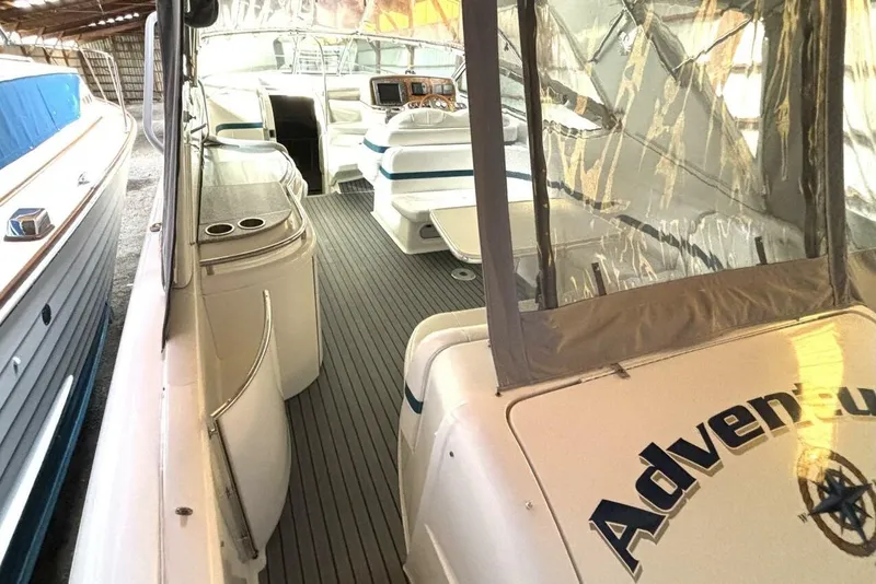 Slide: The Image of 2006 Formula 400 Super Sport Crossover boat interior with seating and helm, docked in a covered area. - 16