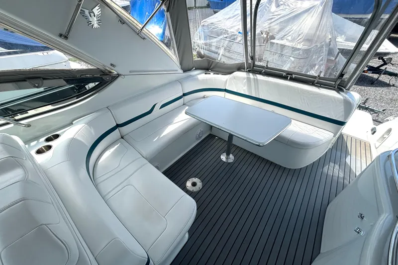 Slide: The Image of Interior of a 2006 Formula 400 Super Sport Crossover boat with white seating and table. - 19