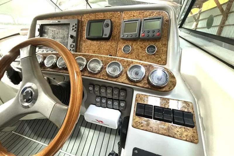 Slide: The Image of Control panel of a 2006 Formula 400 Super Sport Crossover boat with wood accents and gauges. - 28