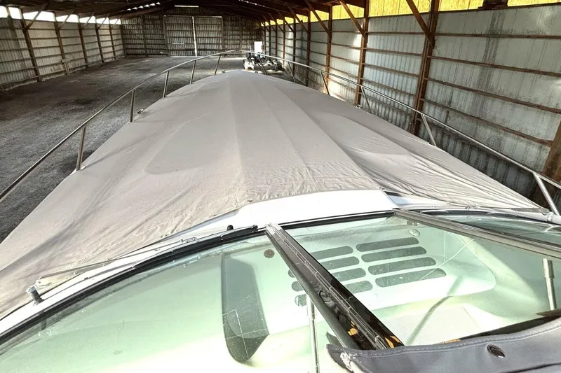 Slide: The Image of 2006 Formula 400 Super Sport Crossover boat covered in storage shed. - 30