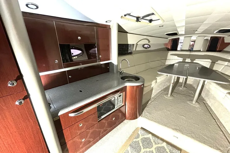 Slide: The Image of Luxurious interior of a 2006 Formula 400 Super Sport Crossover yacht with kitchenette and seating area. - 33