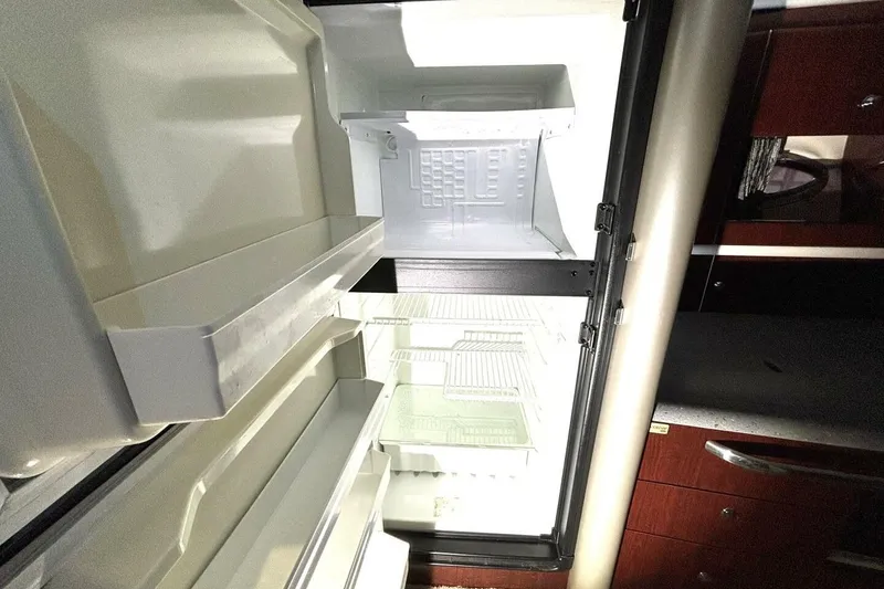 Slide: The Image of Open refrigerator inside a 2006 Formula 400 Super Sport Crossover boat, showing empty shelves. - 35