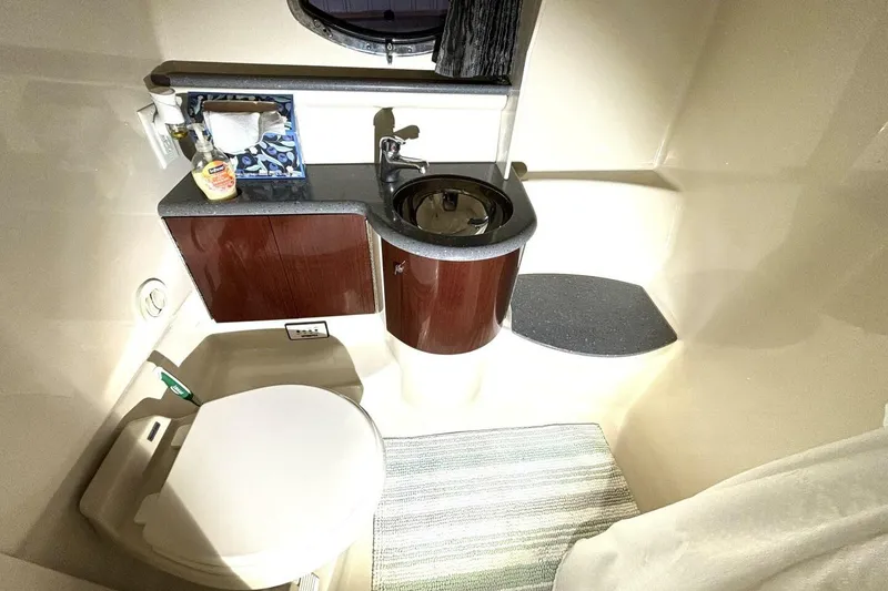 Slide: The Image of Compact bathroom in 2006 Formula 400 Super Sport Crossover boat, featuring sink and toilet. - 43