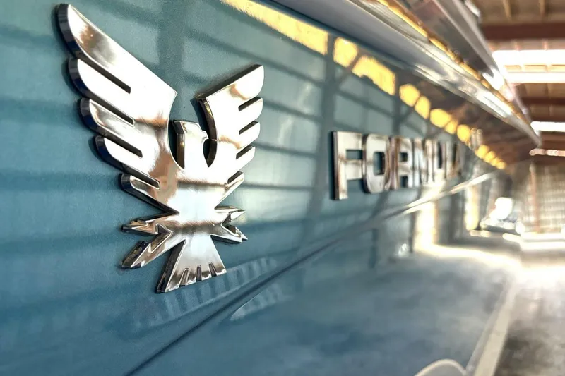 Slide: The Image of 2006 Formula 400 Super Sport Crossover boat emblem in a sunlit setting. - 60