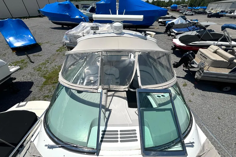 Slide: The Image of 2006 Formula 400 Super Sport Crossover boat in storage yard, surrounded by covered vessels. - 12