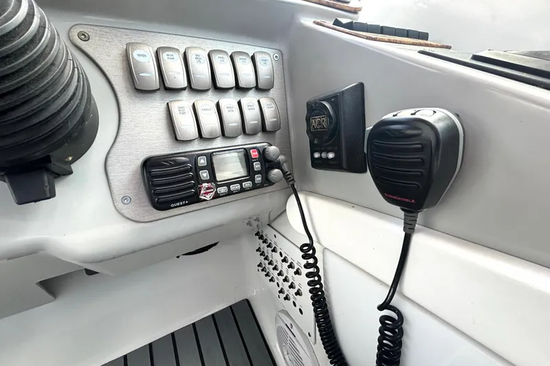 Slide: The Image of Control panel of a 2006 Formula 400 Super Sport Crossover boat with radio and switches. - 31