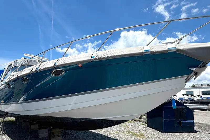 Slide: The Image of 2006 Formula 400 Super Sport Crossover boat on land under a clear blue sky. - 4
