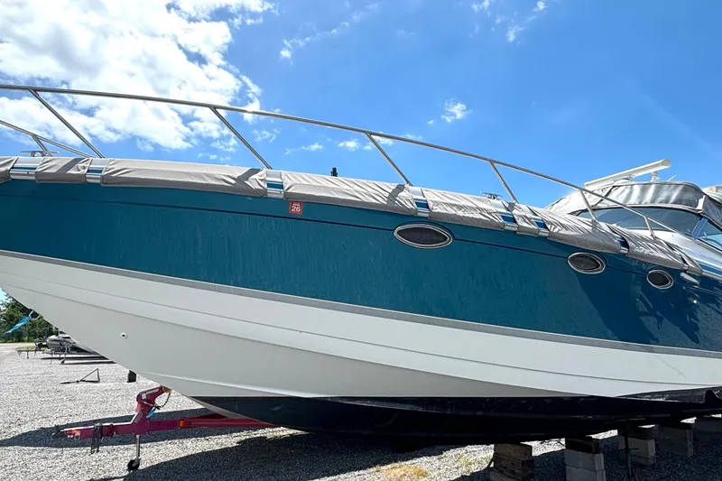 Slide: The Image of 2006 Formula 400 Super Sport Crossover boat on dry dock under a clear blue sky. - 2