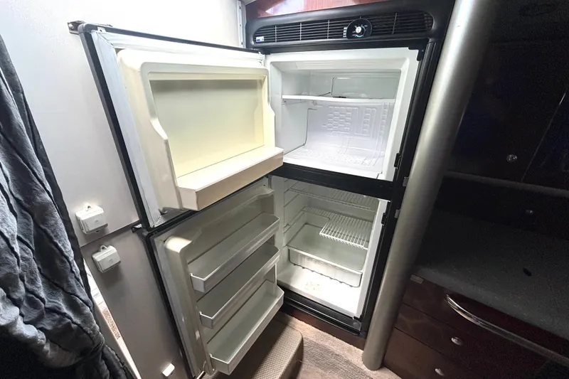 Slide: The Image of Open refrigerator inside a 2006 Formula 400 Super Sport Crossover boat cabin. - 37