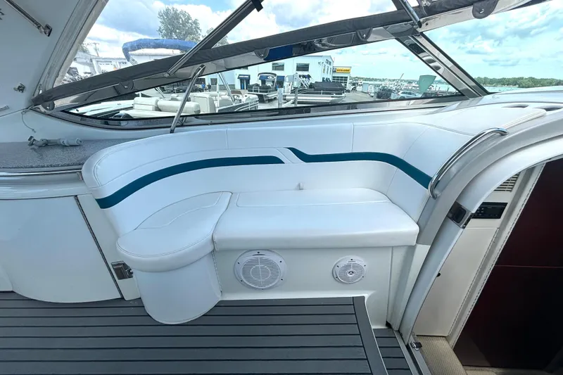Slide: The Image of Interior of 2006 Formula 400 Super Sport Crossover boat with white seating and blue accents. - 24