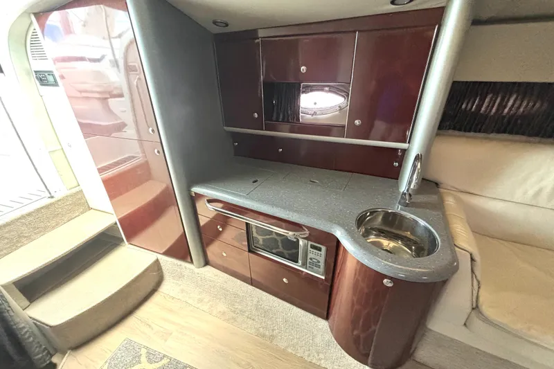 Slide: The Image of Interior of a 2006 Formula 400 Super Sport Crossover boat with kitchenette and sink. - 36