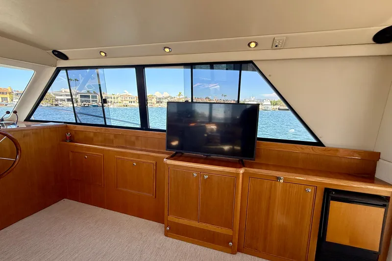 Slide: The Image of Interior of 1998 Riviera 43 Open Flybridge yacht with TV and waterfront view. - 14