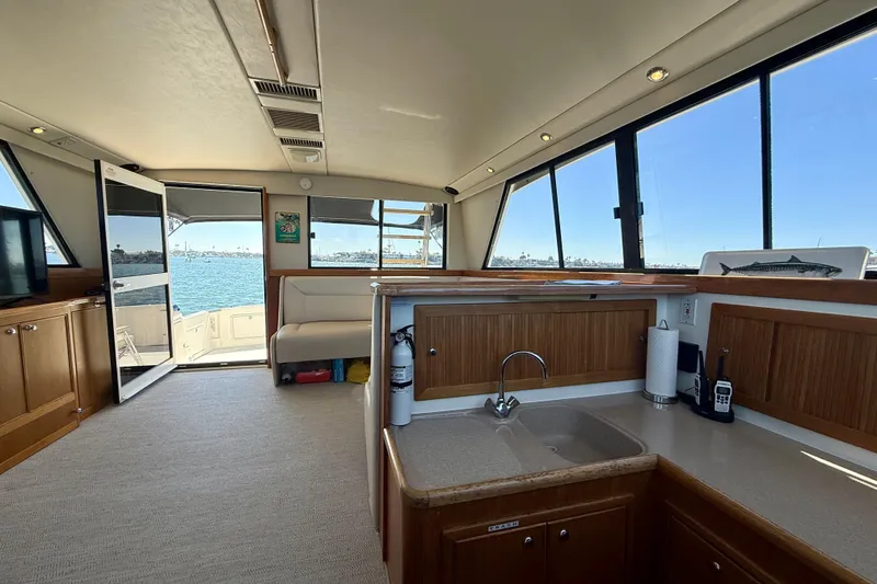 Slide: The Image of Interior of 1998 Riviera 43 Open Flybridge yacht with kitchen and seating area. - 15