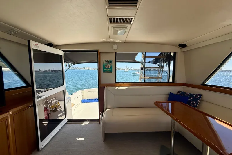 Slide: The Image of Interior of 1998 Riviera 43 Open Flybridge yacht with ocean view through open door. - 21