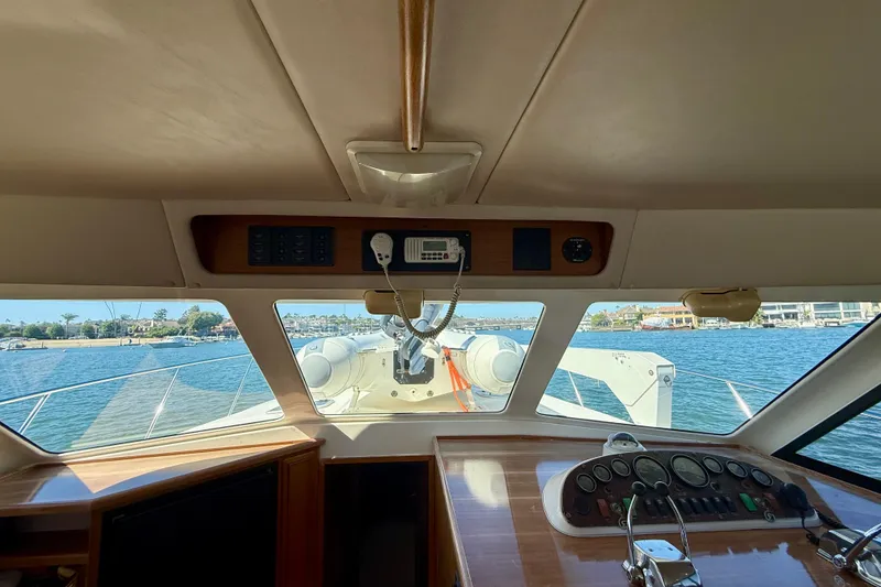 Slide: The Image of Interior view of 1998 Riviera 43 Open Flybridge yacht, showcasing helm and ocean scenery. - 24